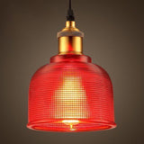 Lit red ribbed glass pendant glowing against a dark backdrop