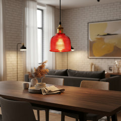 Lit red ribbed glass pendant glowing against a dark backdrop