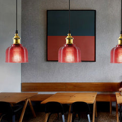 Three red ribbed glass pendants along a cafe banquette table