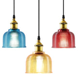 Blue, amber and red bell pendants shown together on white
