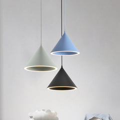 Green, blue and black cone pendants lit above a dining table