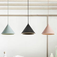 Green, black and pink cone pendants lit under a timber beam