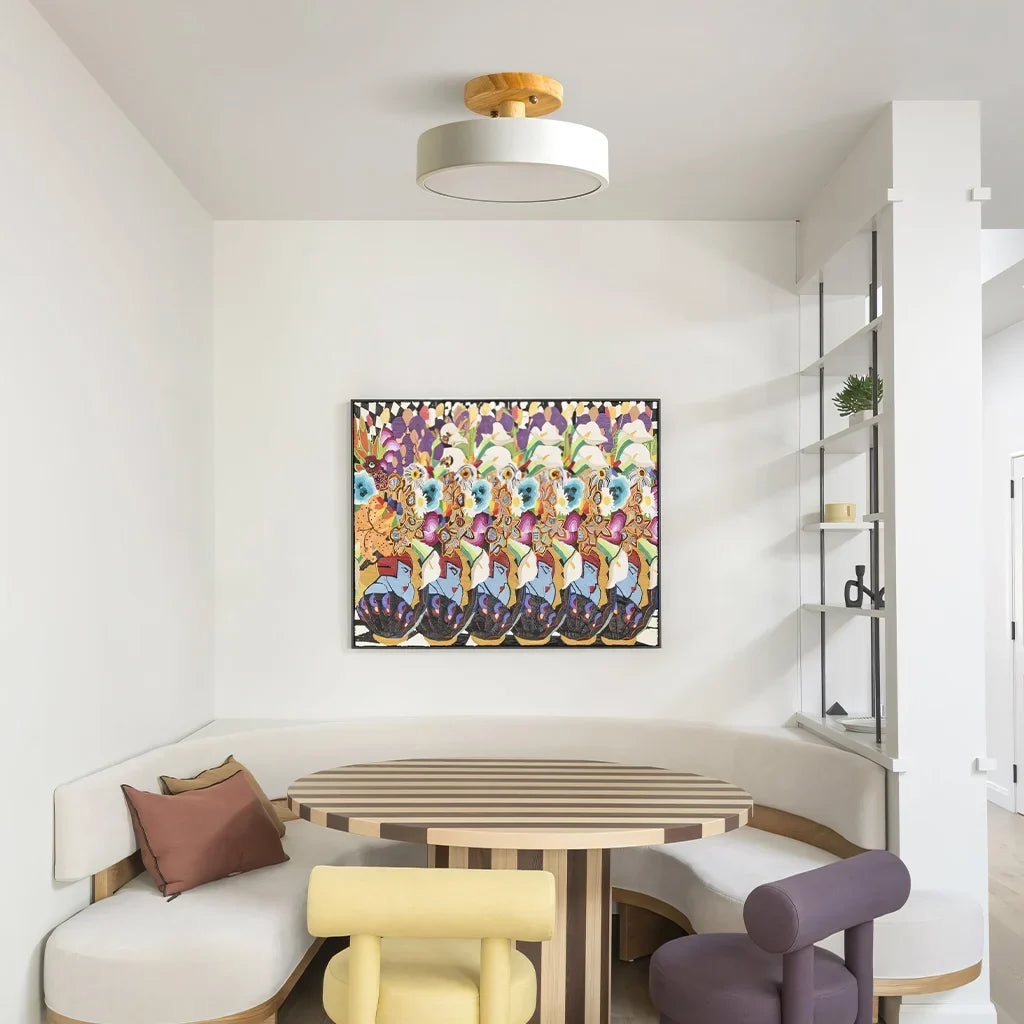 Wood ceiling light glowing softly above a dining table in a cosy room