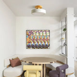 Wood ceiling light glowing softly above a dining table in a cosy room