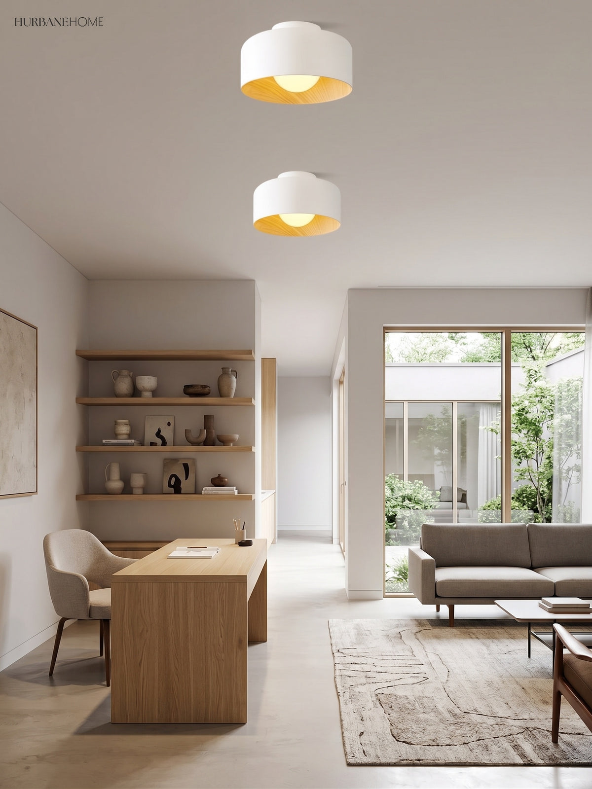 Two white drum ceiling lights above an oak dining table and open shelving