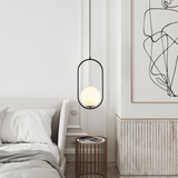 Black round frame glass globe pendant lighting a white sideboard corner