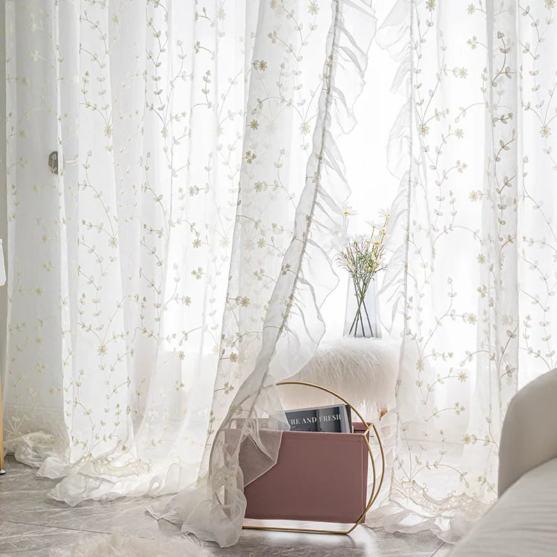 Embroidered floral tulle curtains filtering daylight in bedroom