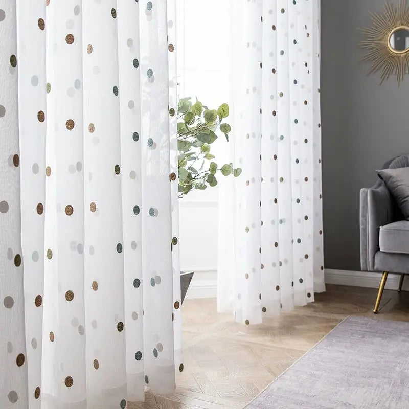 Embroidered white sheer curtains filtering daylight on large windows