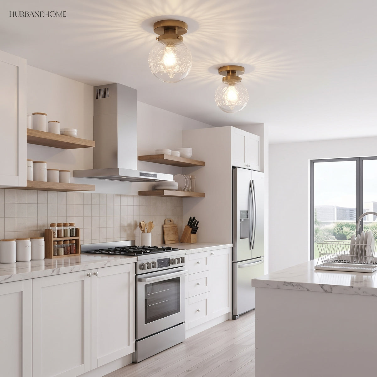 Two clear glass globe ceiling lights above a white kitchen and island