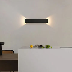 Black waterproof wall light mounted beside a window at twilight
