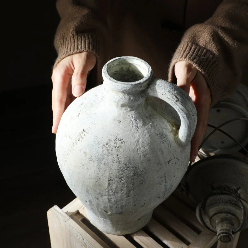 Textured floral ceramic vase on wooden table