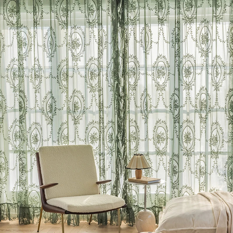 Floral embroidered sheer curtains in dark green tulle, hanging on window for elegant look.