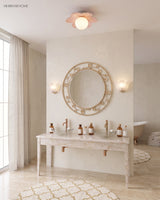 Pink petal flower ceiling light above a pale stone bathroom vanity and mirror