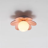 Pink flower ceiling light fitted flat to a white ceiling and casting a soft shadow