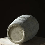 Textured floral ceramic vase on wooden table