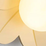 Very close view of the glass globe meeting the edge of a cream coloured petal