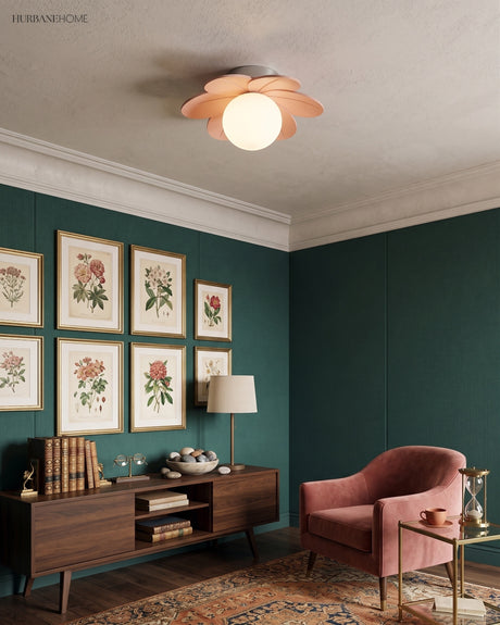 Flower ceiling light on a white ceiling in a dark green room hung with botanical prints