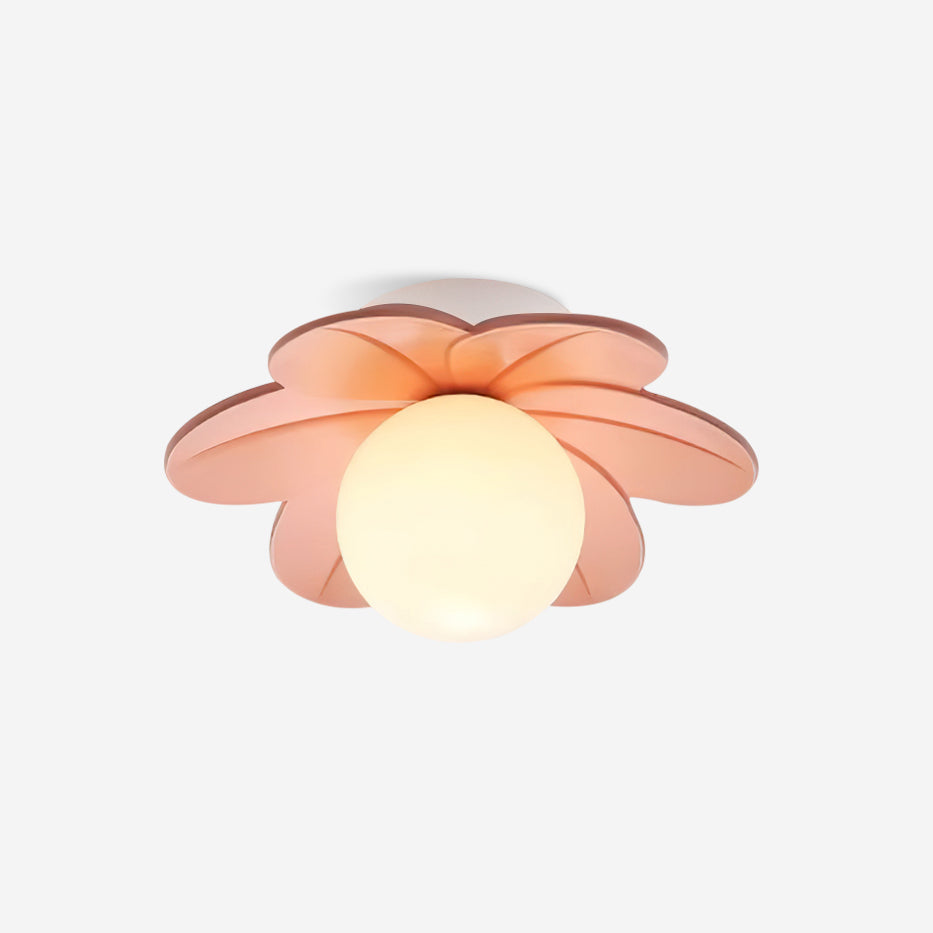 Studio view of the pink petal ceiling light lit, showing the frosted glass globe