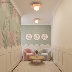 Flower ceiling light in a pale playroom with a picket rail and pink armchair