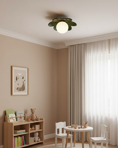 Flower ceiling light in a beige playroom with toy shelves and a small table