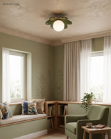 Flower ceiling light in a green sitting room with a cushioned window seat