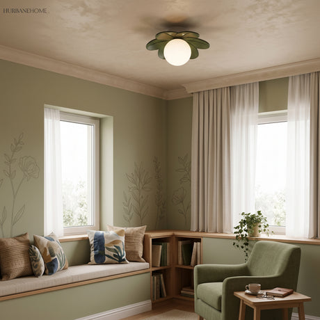 Flower ceiling light in a green sitting room with a cushioned window seat