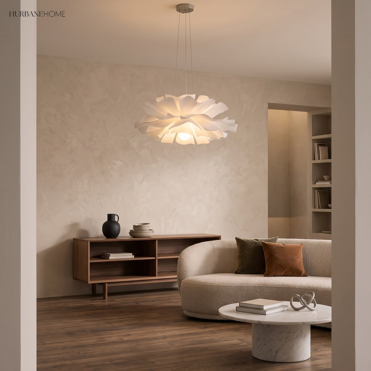 White flower pendant light over a lounge with sofa and shelving