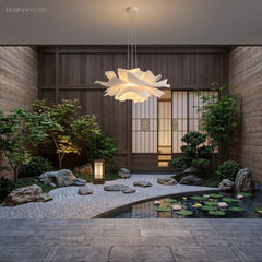 White lotus petal pendant light above a bench by a courtyard garden