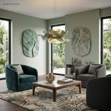 Sage green flower pendant light in a green lounge with armchairs