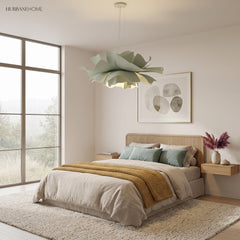 Sage green flower pendant light above a bed in a calm bedroom