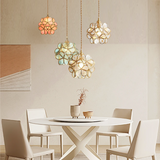 Lit flower petal glass pendant light casting a warm central glow