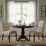 Flower table lamp on a round pedestal dining table in a bright bay window nook