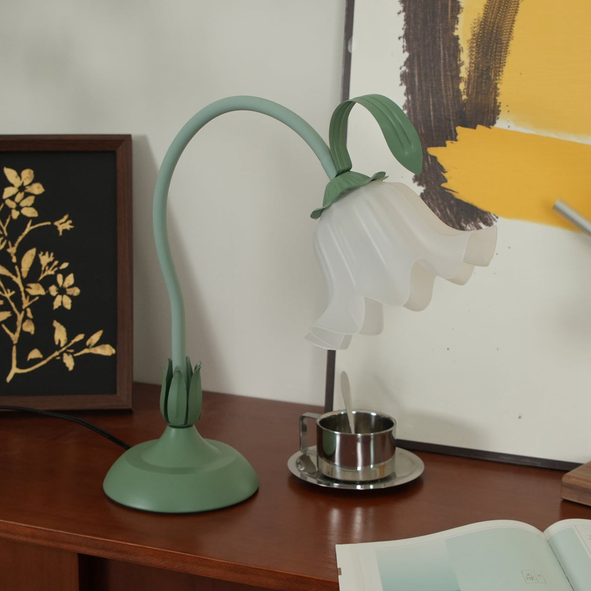 Flower table lamp with a hooked stem lit above a small chrome dish