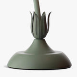 Close view of the green leaf collar and the round dome base of the lamp