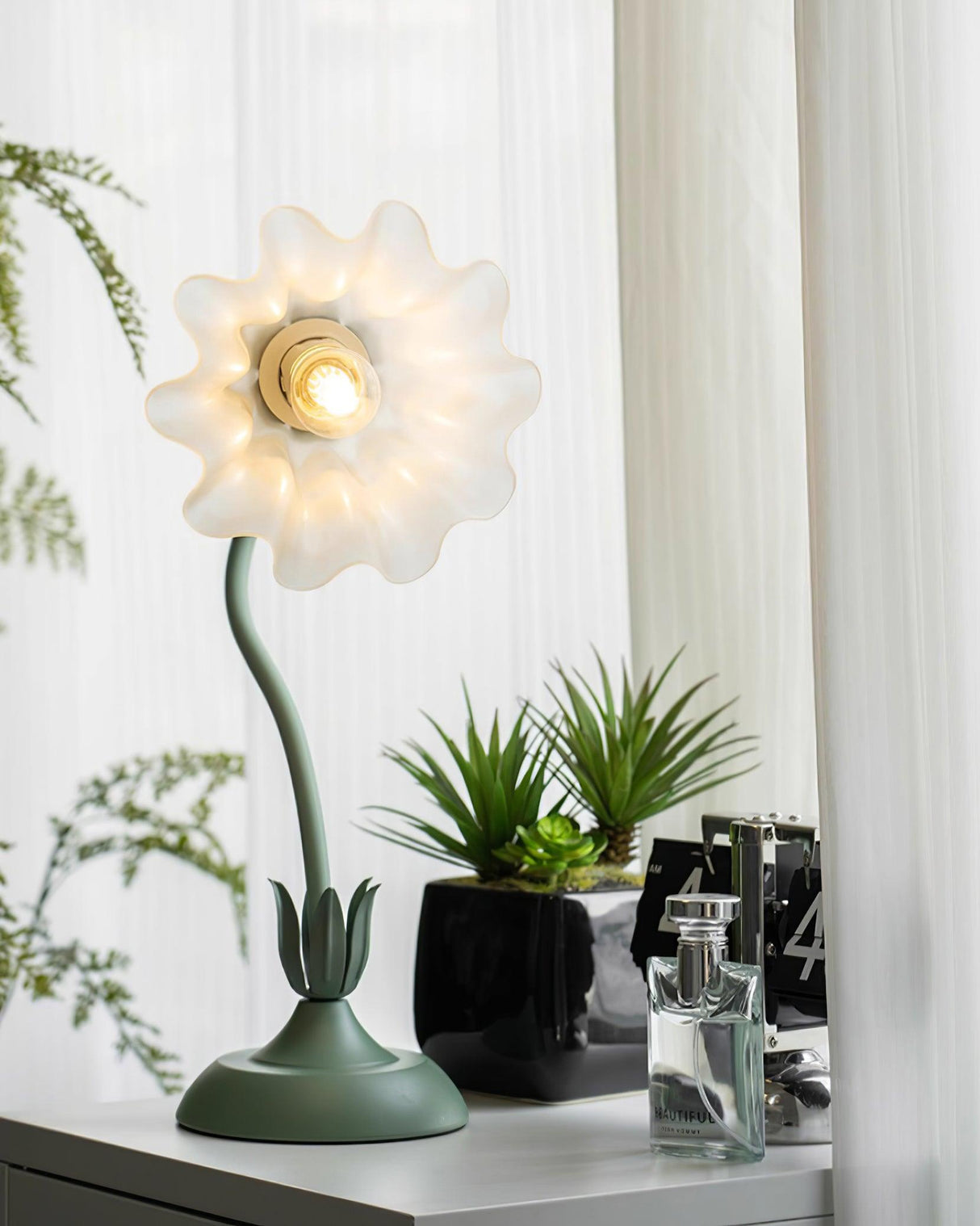 Front view of the flower shade with petals fully open around the lit bulb