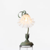 Studio image of the shade opened upward with petals fanned around the bulb
