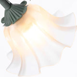 Underside of the lit petal shade showing the ruffled edges and green calyx