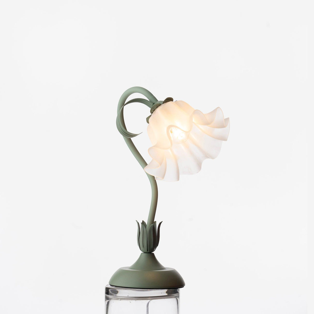 Angled studio view of the lamp with its shade tipped down over the stem