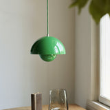 Flowerpot pendant light hanging above modern dining table