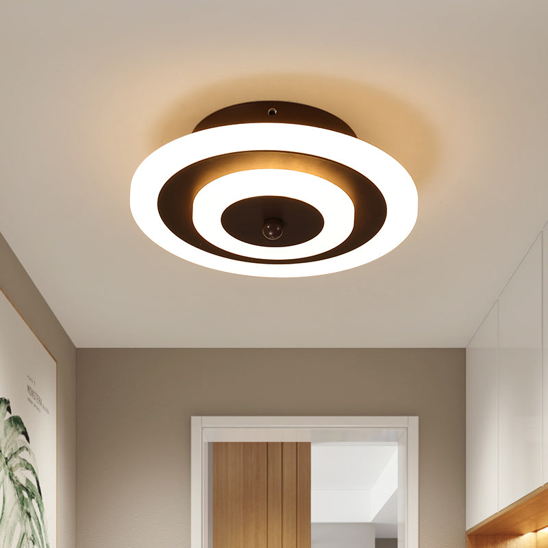 Round ceiling light lit warm on a plain hallway ceiling