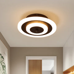 Round ceiling light lit warm on a plain hallway ceiling
