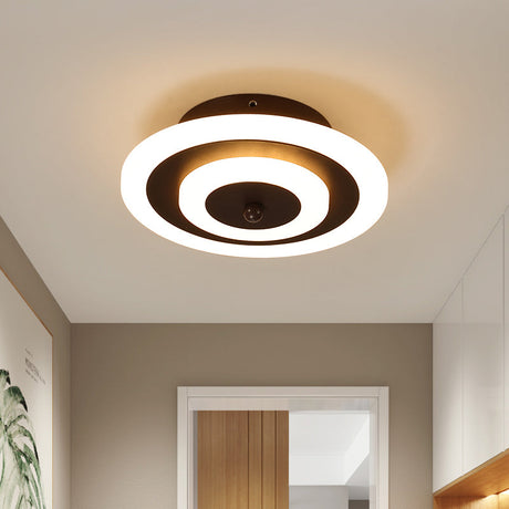 Round ceiling light lit warm on a plain hallway ceiling