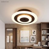 Round ceiling light with a coffee ring lighting a study alcove