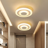 Two round ceiling lights in a corridor with recessed shelving