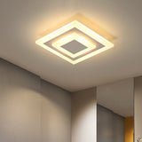 Square ceiling light lit warm in the corner of a white ceiling
