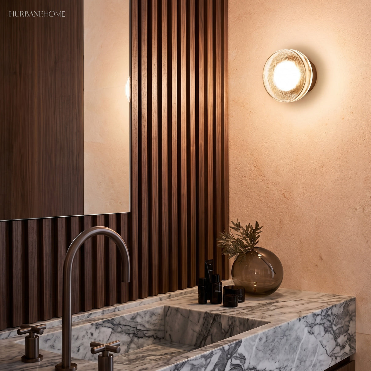 Gold ribbed wall light lit against a slatted timber bathroom wall