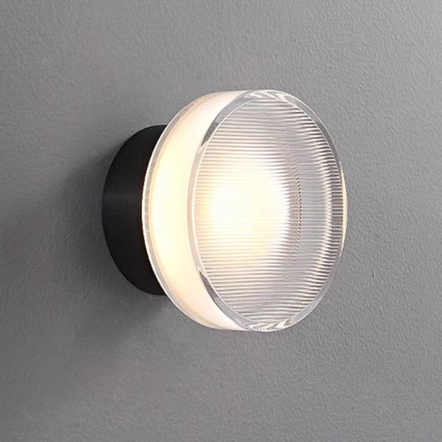 Two ribbed disc wall lights mounted on a white slatted wall