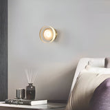 Ribbed disc wall light seen from an angle beside a kitchen doorway