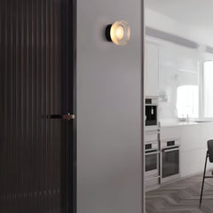 Gold ribbed wall light on a plain white wall at an angle