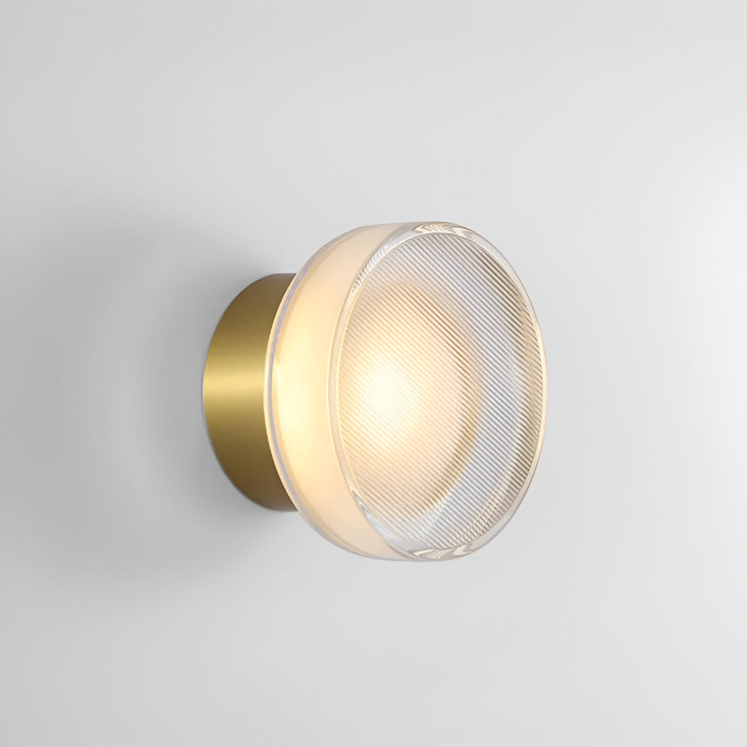 Black ribbed wall light on a plain white wall at an angle